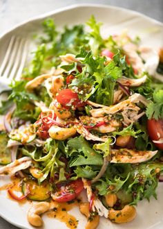 a white plate topped with a salad covered in lots of veggies