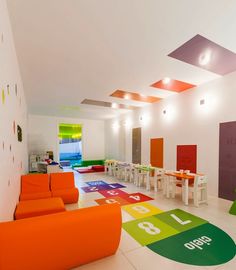 a brightly colored children's playroom with lots of furniture