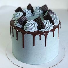 a cake with white frosting and chocolate toppings