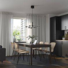 a dining room table and chairs in front of a window