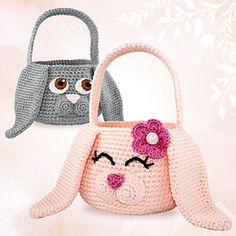 two crocheted purses with faces on them, one is pink and the other is gray