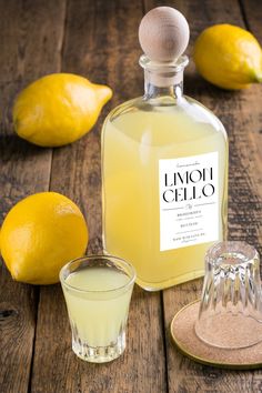 a bottle of limoo celio next to some lemons and a glass cup