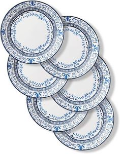 six blue and white dinner plates on a white background with an ornate design in the center