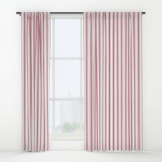 a red and white striped curtain hanging in front of a window