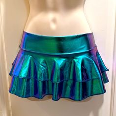 The Color Is A Shimmering, Holographic Blue-Green. Very Shiny. I Would Call It “Mermaid Blue” Sz. Small. Made To Show Off Your Cheeks. A Great Addition To Your Electric Rave Attire. Blue Fitted Mermaid Skirt, Blue Stretch Mermaid Bottoms, Stretch Blue Mermaid Bottoms, Summer Party Mermaid Bottoms, Blue Fitted Skirt With Ruffles, Fitted Blue Skirt With Ruffles, Fitted Green Skort With Ruffles, Blue Fitted Tiered Mini Skirt, Blue Stretch Ruffle Skort