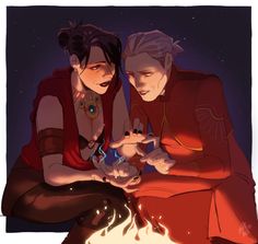 two people sitting next to each other near a fire