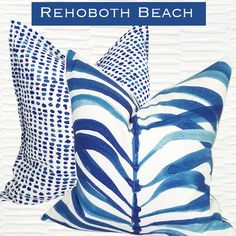 two blue and white pillows with the words rehoboth beach on it in front of them