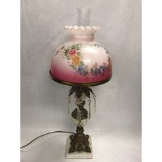 a pink lamp sitting on top of a white table