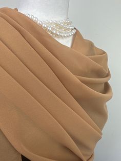 Elevate your style with our exquisite collection of chiffon shawls. Our chiffon shawls are the epitome of elegance and versatility, designed to effortlessly enhance your wardrobe and leave a lasting impression. Made from the fine poly chiffon fabric, these shawls offer a delicate and airy drape that adds a touch of grace to any outfit. Whether you're attending a special occasion, a casual gathering, or simply want to elevate your everyday look, our chiffon shawls are the perfect accessory. Choos Elegant Cream Scarf For Formal Occasions, Elegant Beige Formal Shawl, Elegant Beige Scarf For Formal Occasions, Elegant Cream Shawl Scarf, Elegant Chiffon Shawl, Elegant Formal Shawl, Elegant Gold Scarf For Evening, Elegant Gold Scarf For Wedding, Elegant Silk Chiffon Scarves For Wedding