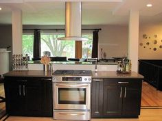 a modern kitchen with stainless steel appliances and black cabinets