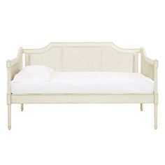 a white daybed with pillows on it