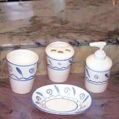 a bathroom set with soap dispenser, toothbrush holder and cups