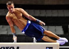 a shirtless man is doing tricks on a trampoline