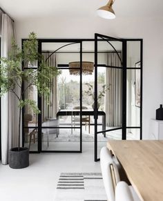 an open living room and dining area with glass doors