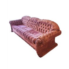 a pink velvet couch with tufted back and arms, on an isolated white background