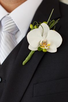 a man in a suit with a boutonniere on his lapel