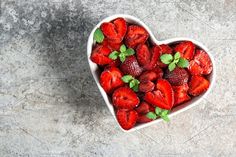 fresh strawberries in a heart shaped bowl