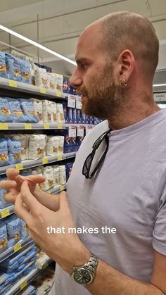 a man with a stethoscope looking at food in a grocery store aisle