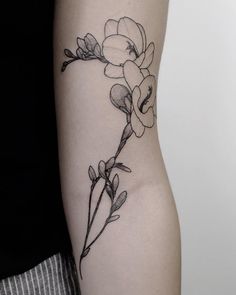 a black and white photo of a flower on the left side of the right arm