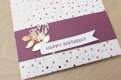 a close up of a birthday card with a flower on the front and a happy birthday sign on the back