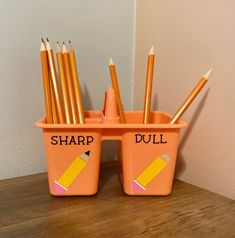 there are pencils in the cup with sharp and dull written on them