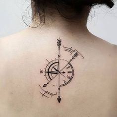 a woman with a compass tattoo on her back