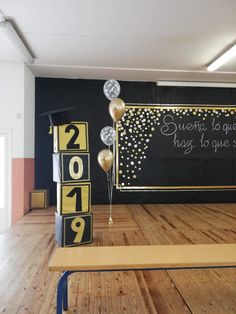 an empty room with balloons and signs on the wall for new year's eve