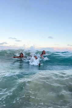 two people are swimming in the ocean together