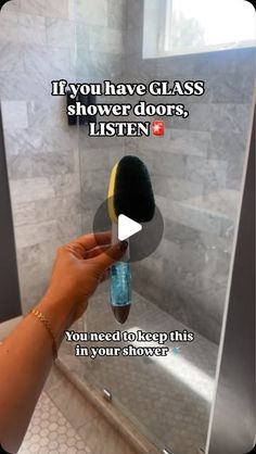 a person is holding a brush in front of a mirror with the words if you have glass shower doors, listen