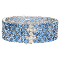 18k white gold aquamarine and diamond multi row link tennis bracelet. Featuring 5 rows of oval-cut aquamarines, with bezel set round cut diamonds on the closure. Bearing 129 aquamarines in 4-prong settings that dazzle a vibrant dance of ocean blue color as you move. This is a noticeably valuable piece that breaks the traditional mold of typically gemstone tennis bracelets. Item Details: - Type: Multi Row Tennis Bracelet - Metal: 18K White Gold - Weight: 45.15 Grams - Length: 7.25 inches - Settin Aquamarine Jewelry Bracelet, Ocean Blue Color, Bracelet Tennis, Aquamarine Bracelet, Bracelet Metal, Expensive Jewelry, Aqua Marine, Art Deco Diamond, Dream Jewelry