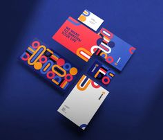 three different business cards on a blue surface