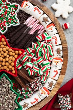 a platter filled with christmas cookies and candy