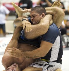 two men are wrestling in a competition