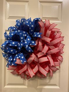 a red, white and blue wreath on a door