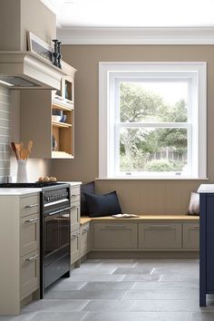 a kitchen with an oven, sink, and window seat in it's center