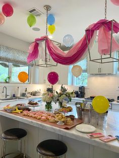 a kitchen filled with lots of food and balloons