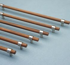 six wooden and metal handles on a blue surface