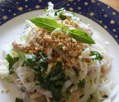 a white plate topped with lots of food on top of a blue and white table