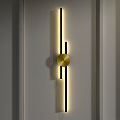 a wall mounted light on the side of a white door with a yellow circle in it