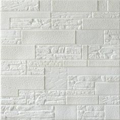 a white brick wall that is made out of different types of bricks