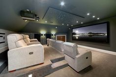 a home theater with two recliners and a projector