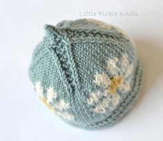 a knitted ball sitting on top of a white table