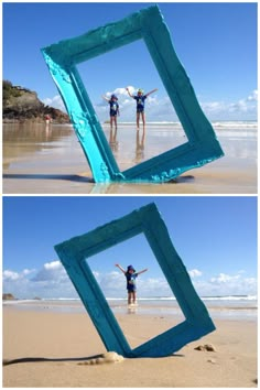 two people standing on the beach with their arms in the air and one person holding an object