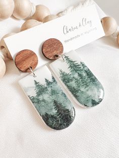 the earrings are made from wood and have trees painted on them