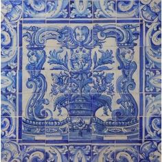 a blue and white tile with an ornate design