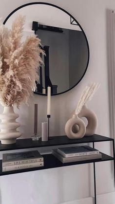 a mirror and some vases on a shelf in front of a radiator