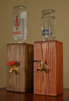 two wooden boxes with water bottles on top of them