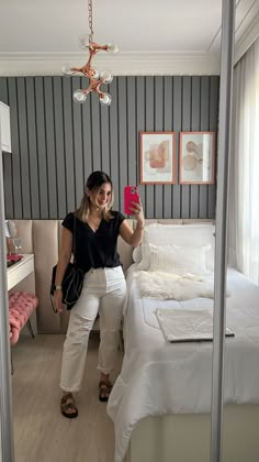 a woman taking a selfie in her bedroom