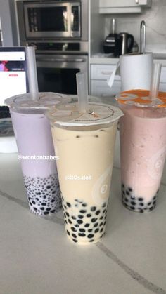 three drinks sitting on top of a kitchen counter