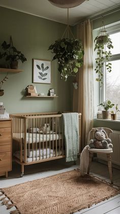 a baby's room with green walls and plants